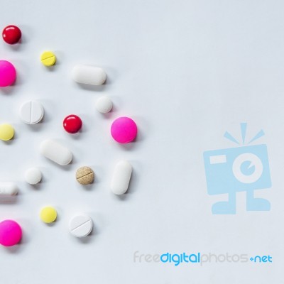 Top View Of The Pills On The White Background, The Drug And Capsule Pills On The Floor Stock Photo