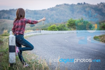 Tourist Hitchhiking Woman Standing On The Road In The Mountains Stock Photo