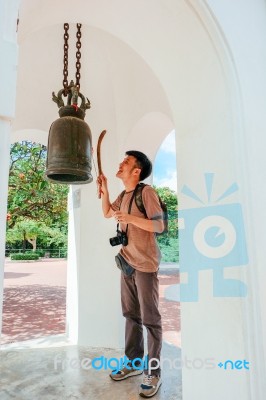 Tourist Man Knock The Metal Bell In Thai Temple Stock Photo