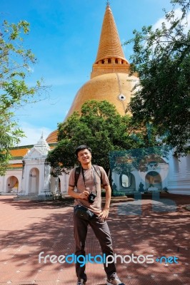 Tourist Man With Camera Standing In Front Og Thai Pagoda Temple Stock Photo