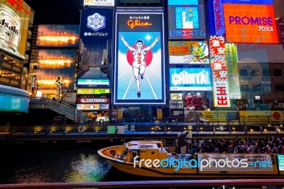 Tourist Walking In Night Shopping Street At Dotonbori In Osaka, Japan  Stock Photo