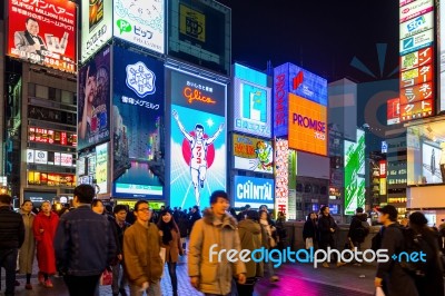 Tourist Walking In Night Shopping Street At Dotonbori In Osaka, Japan Stock Photo