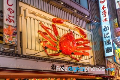 Tourist Walking In Night Shopping Street At Dotonbori In Osaka, Japan Stock Photo