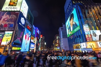 Tourist Walking In Night Shopping Street At Dotonbori In Osaka, Japan Stock Photo