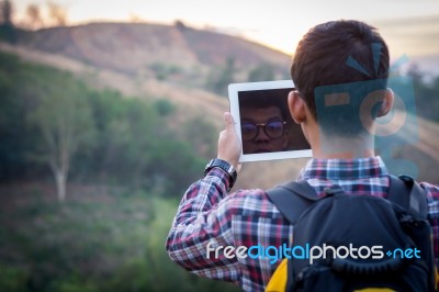 Tourists Man Are Taking Photos With A Tablets Stock Photo