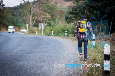 Tourists Man Walk Along Mountain Roads Stock Photo