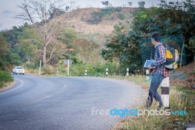 Tourists Man Walk Along Mountain Roads Stock Photo