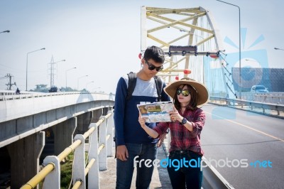 Tourists Read The Map On The Bridge Stock Photo