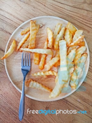 Traditional French Fries On Wood Background Stock Photo