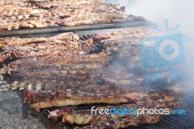 Traditional Meat Grilled On The Grill In The Argentine Countryside Stock Photo