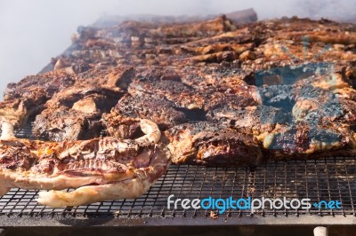 Traditional Meat Grilled On The Grill In The Argentine Countryside Stock Photo