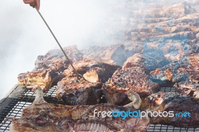 Traditional Meat Grilled On The Grill In The Argentine Countryside Stock Photo