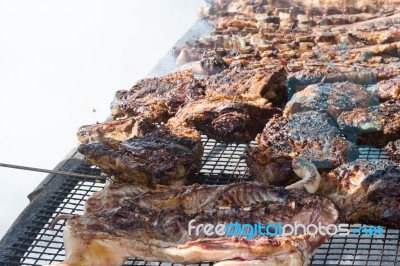 Traditional Meat Grilled On The Grill In The Argentine Countryside Stock Photo