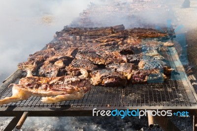 Traditional Meat Grilled On The Grill In The Argentine Countryside Stock Photo