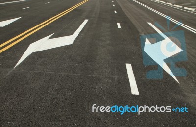 Traffic Sign On Black Asphalt Road Stock Photo