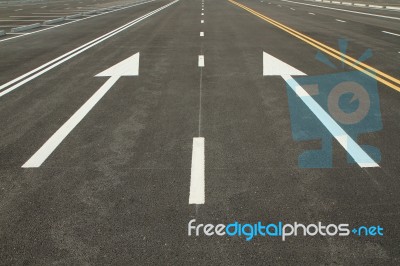 Traffic Sign On Black Asphalt Road Stock Photo