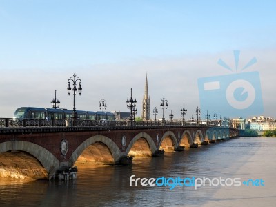 Tram Passing Over The Pont De Pierre Spanning The River Garonne Stock Photo