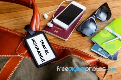 Travel Bag With Insurance Tag And Tourist Accessories Stock Photo