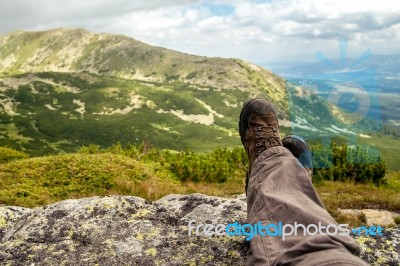 Trekker Resting In The Mountains Stock Photo