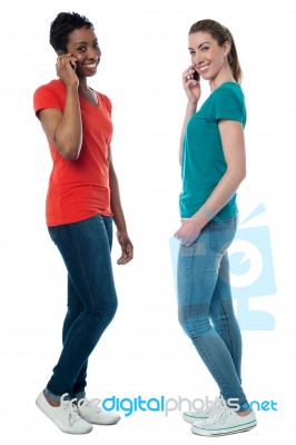 Trendy Females Speaking Over Cellphone Stock Photo