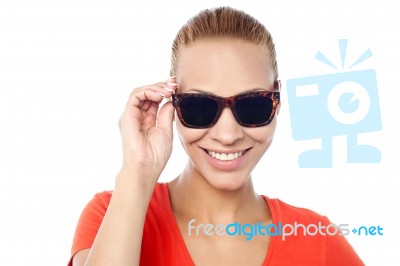 Trendy Woman Adjusting Her Sunglasses Stock Photo