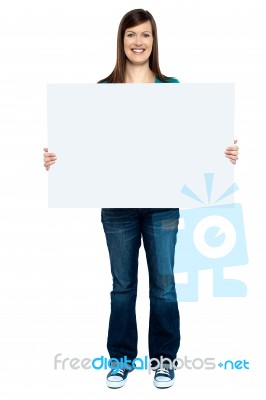 Trendy Woman Showing Blank Billboard To Camera Stock Photo