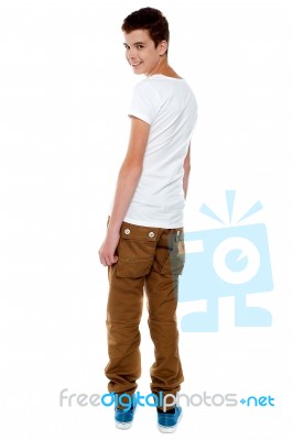 Trendy Young Boy Turning Back Stock Photo