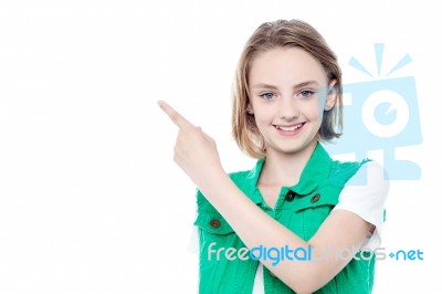 Trendy Young Girl Pointing Away Stock Photo