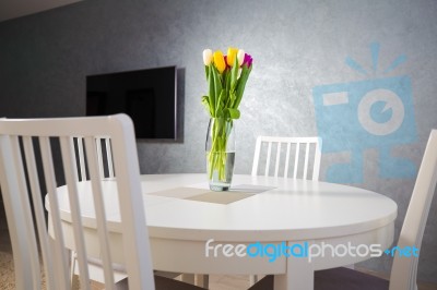 Tulips On White Dining Table Stock Photo