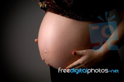 Tummy Of Pregnant Woman Stock Photo