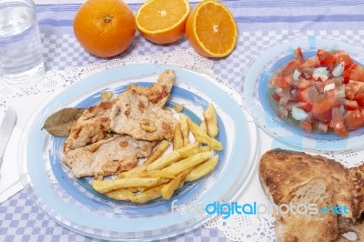 Turkey Steak With French Fries And Tomato Salad Stock Photo