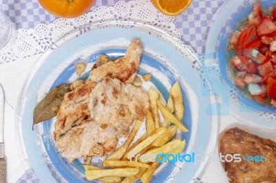 Turkey Steak With French Fries And Tomato Salad Stock Photo