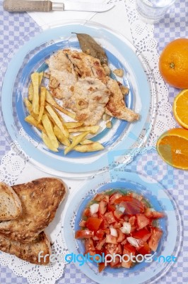 Turkey Steak With French Fries And Tomato Salad Stock Photo