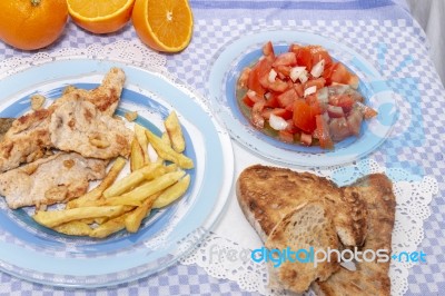 Turkey Steak With French Fries And Tomato Salad Stock Photo