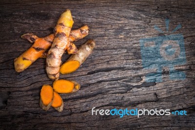 Turmeric Root On Wooden Plate With Copy Space For Text Stock Photo