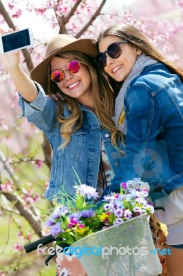 Two Beautiful Young Women Taking A Selfie In The Field Stock Photo