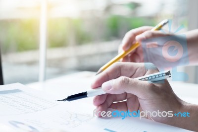 Two Business Partners Analysing A Financial Report Discussing Th… Stock Photo