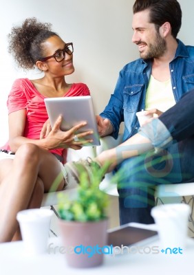 Two Business People Using A Digital Tablet At Office Stock Photo