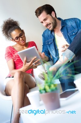 Two Business People Using A Digital Tablet At Office Stock Photo