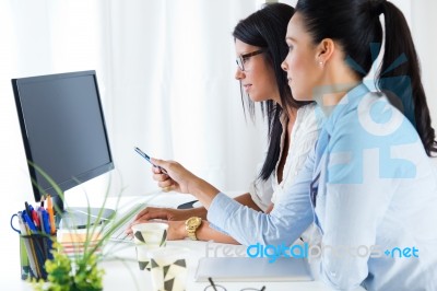 Two Business Woman Working In Office With Computer Stock Photo