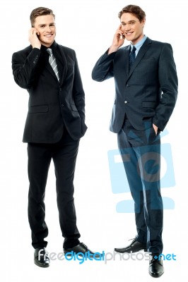 Two Businessmen Talking On Cellphone Stock Photo