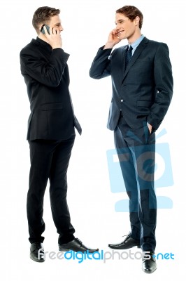 Two Businessmen Talking On Cellphone Stock Photo