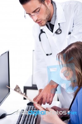 Two Busy Doctors Discussing With The Medical Reports Stock Photo