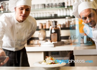 Two Chefs Working As A Team Stock Photo