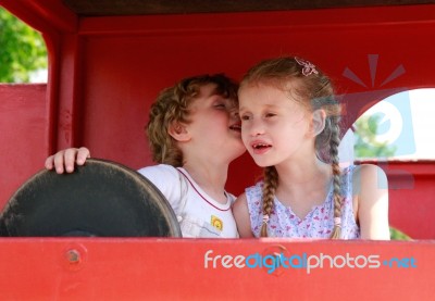 Two Children Whispering Stock Photo