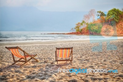 Two Deckchair Canvas On Sand At The Tropical Beach Background Stock Photo