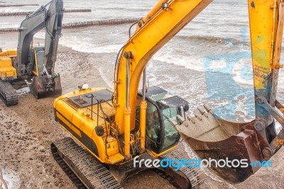 Two Excavators Riding On The Beach Stock Photo