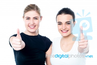 Two Girls Cheering Via With Thumbs Up Gesture Stock Photo