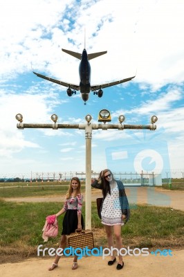 Two Girls Hitchhiking A Plane Stock Photo