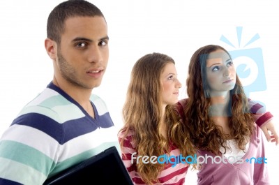 Two Girls Holding To Each Other And Guy Looking At Camera Stock Photo